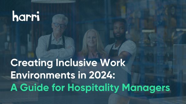 three hospitality employees stand with arms crossed